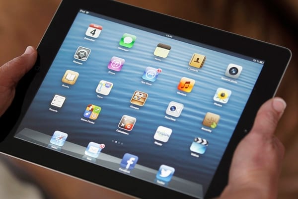 iPad-held-in-hand-showing-app-icons